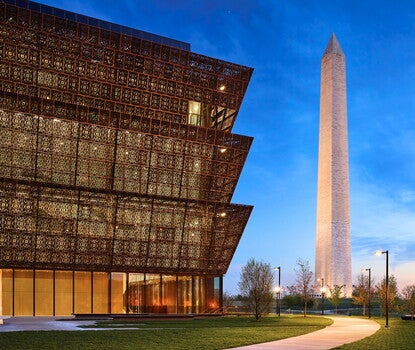 Image of the National Museum of African American History and Culture with the Washington Monument in the distance. 