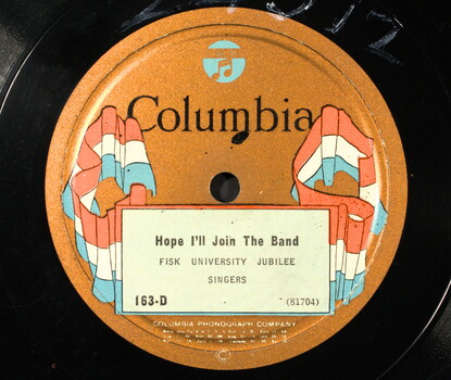 Vinyl record with a brown Columbia records label, adorned with red, white, and blue banners, and the title and artist ("Hope I'll Join the Band," Fisk University Jubilee Singers.)