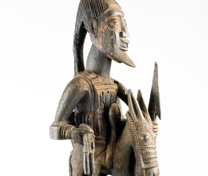 A stylized post of (from top to bottom) a bearded man atop a horse, held up by a woman.