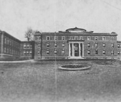 A photograph of a large brick hospital building with multiple wings.