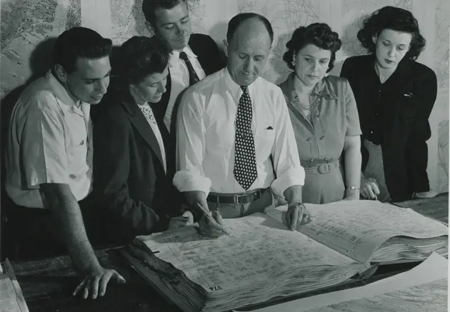 Census Supervisor Instructing Census workers how to use maps