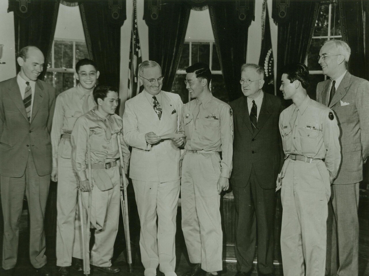 T/Sgt. Kuwayama presenting President Truman with a check contributed by members of the 442nd for a memorial to President Roosevelt [Sept. 11, 1945]