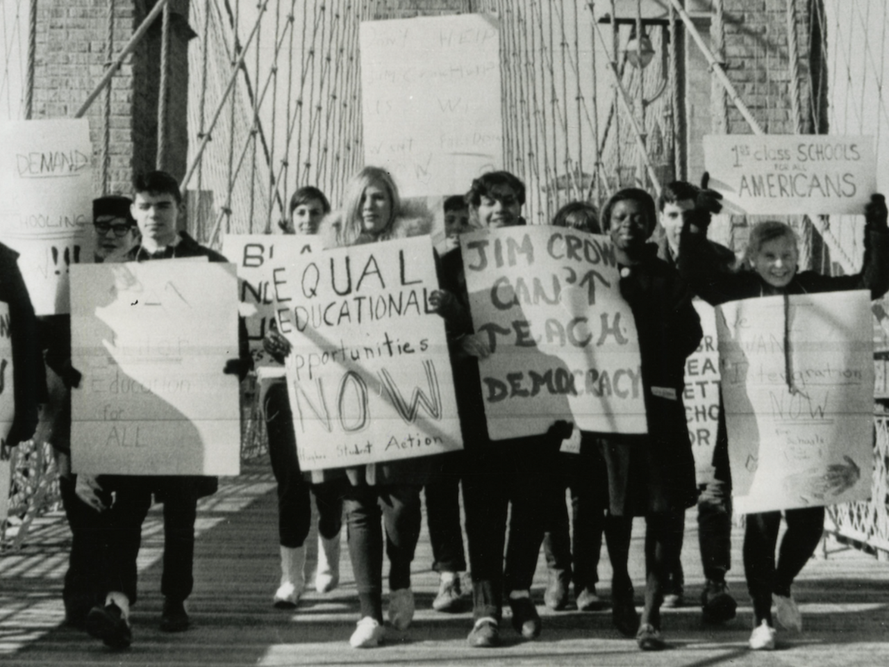 Black and white photograph of students protesting on Brooklyn Bridge