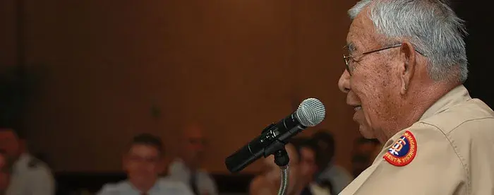 Photograph of Joe Morris Sr. giving a talk at a lectern displaying the NASA logo.