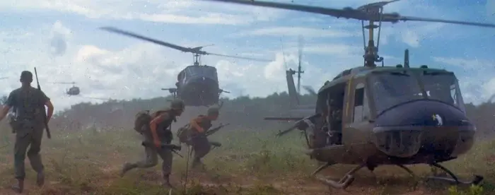 American soldiers running to a helicopter