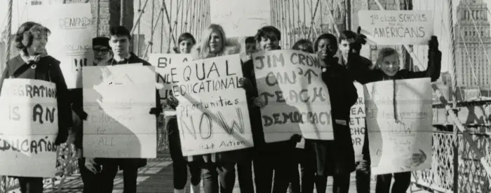 Black and white photograph of students protesting on Brooklyn Bridge