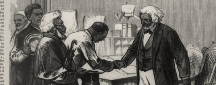 An engraving of a white-haired Frederick Douglass standing at a desk, wearing a dark jacket and waistcoat, dark bow tie, and white shirt and pants, shaking the hand of another Black man as other people wait to greet him at left