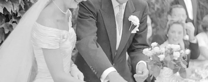 John F. and Jackie Kennedy cut their wedding cake. 