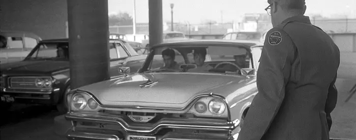 U.S. immigration officer watches as car enters El Paso, Texas, from Ciudad Juárez