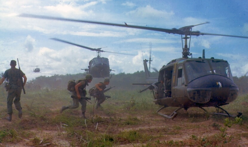 American soldiers running to a helicopter