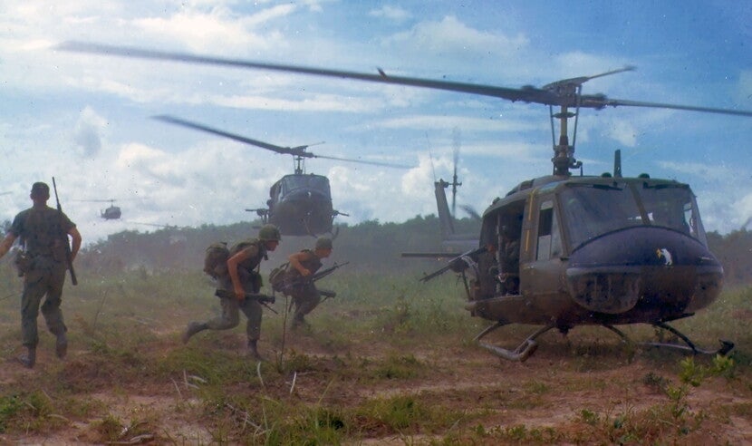 American soldiers running to a helicopter