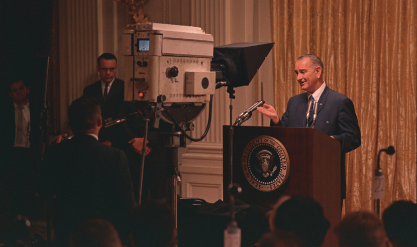 Lyndon Johnson at podium speaking to TV camera 1965
