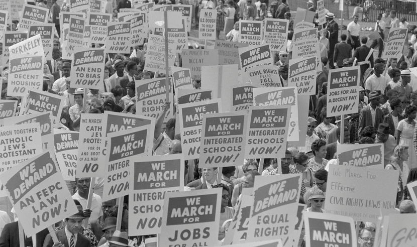 Black and white photograph showing the protest signs at the 1963 march on Washington, D.C. 