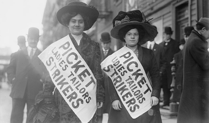 A photograph of two female strikers from Ladies Tailors union on the picket line.