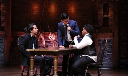 Three students on the Hamilton Musical set performing as part of the EduHam program