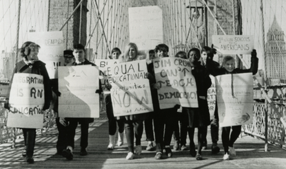 Black and white photograph of students protesting on Brooklyn Bridge