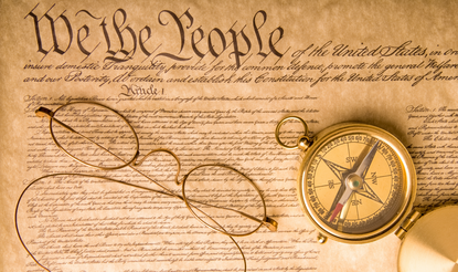A pair of spectacles laying on the Constitution