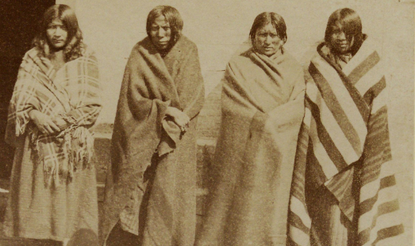A photograph of four Indigenous women standing in a row.
