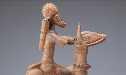 Stylized clay sculpture of an armored soldier on a horse