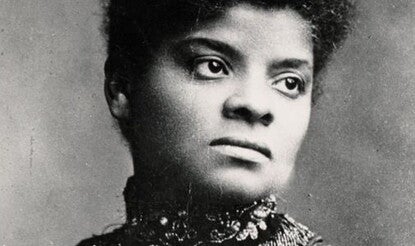 A portrait of Ida B. Wells. She is wearing a striped, high-necked dress and her hair is in a bun.  