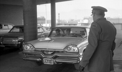 U.S. immigration officer watches as car enters El Paso, Texas, from Ciudad Juárez