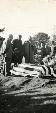 Black and white photograph showing flag draped over a coffin for a soldier's funeral