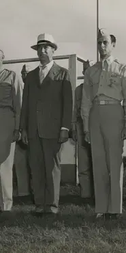 Black and white photograph of a father and son in a military uniform at a medal ceremony