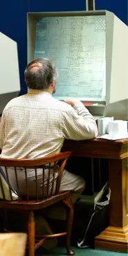 Researcher using a microfilm machine.