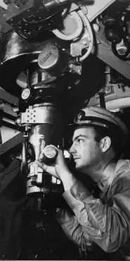 Black and white photograph showing a naval officer looking through a periscope.