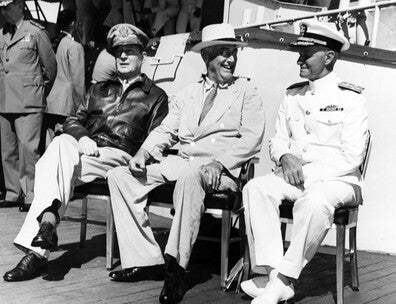 On board USS Baltimore (CA-68), at Pearl Harbor, Hawaii, 26 July 1944. Admiral William D. Leahy, the President's Chief of Staff, is standing in the left background. Official U.S. Navy Photograph, now in the collections of the National Archives