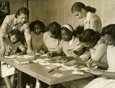 1947 photograph showing American Red Cross volunteers working with teenage girls from Tuskegee Institute High School