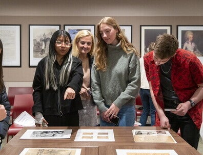 McCormick Family Foundation–Gilder Lehrman Scholars Elisabet Guerrero Hernandez ’25, Olivia Korach ’26, and Ethan Roy ’26 review documents from the Gilder Lehrman Collection alongside Kim Viggiano ’00.