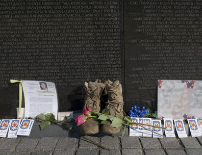 Photograph showing boots in front of the Vietham Memorial in Washington, D.C.