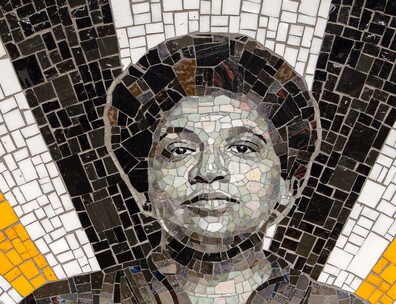 A mosaic featuring a black-and-white portrait of Audre Lorde surrounded by bursts of gold, white, and black tiles.