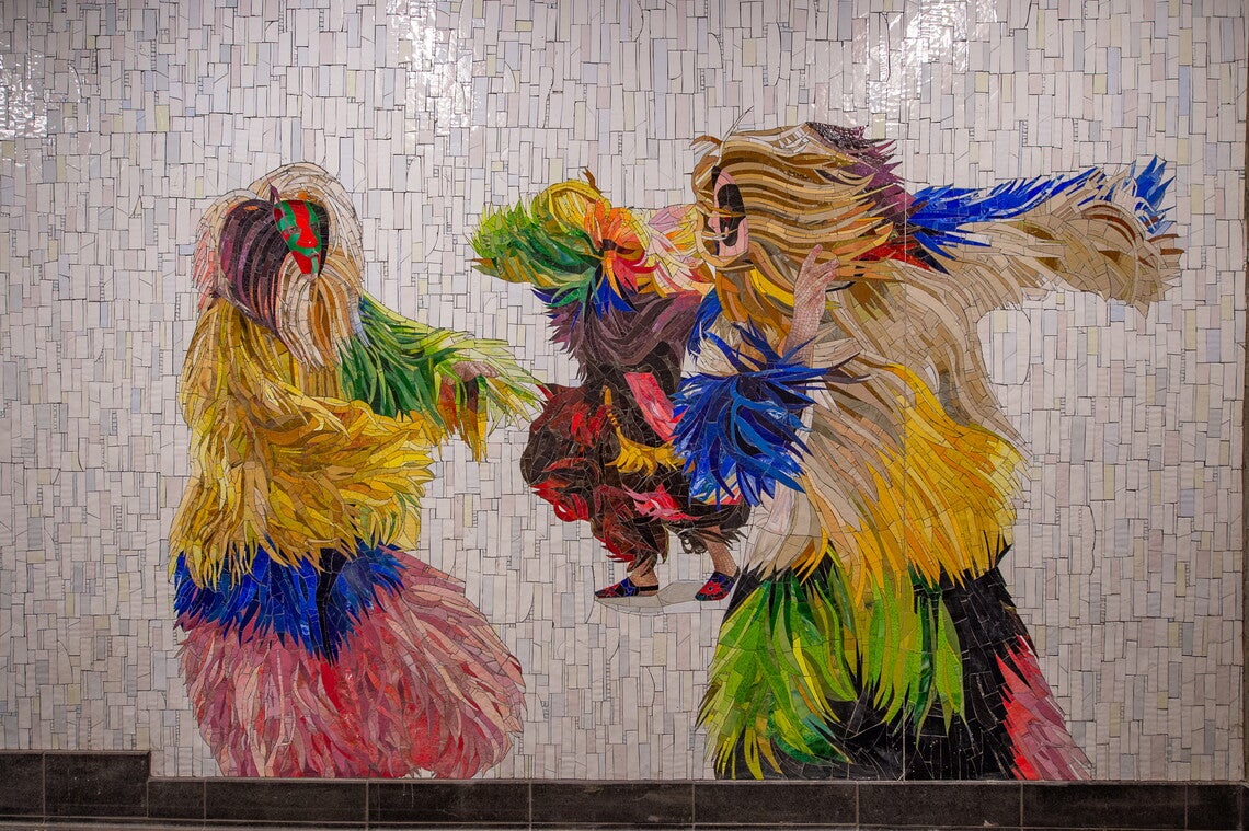 A tiled mosaic of three masked human figures dancing in long-fringed, multicolored body suits