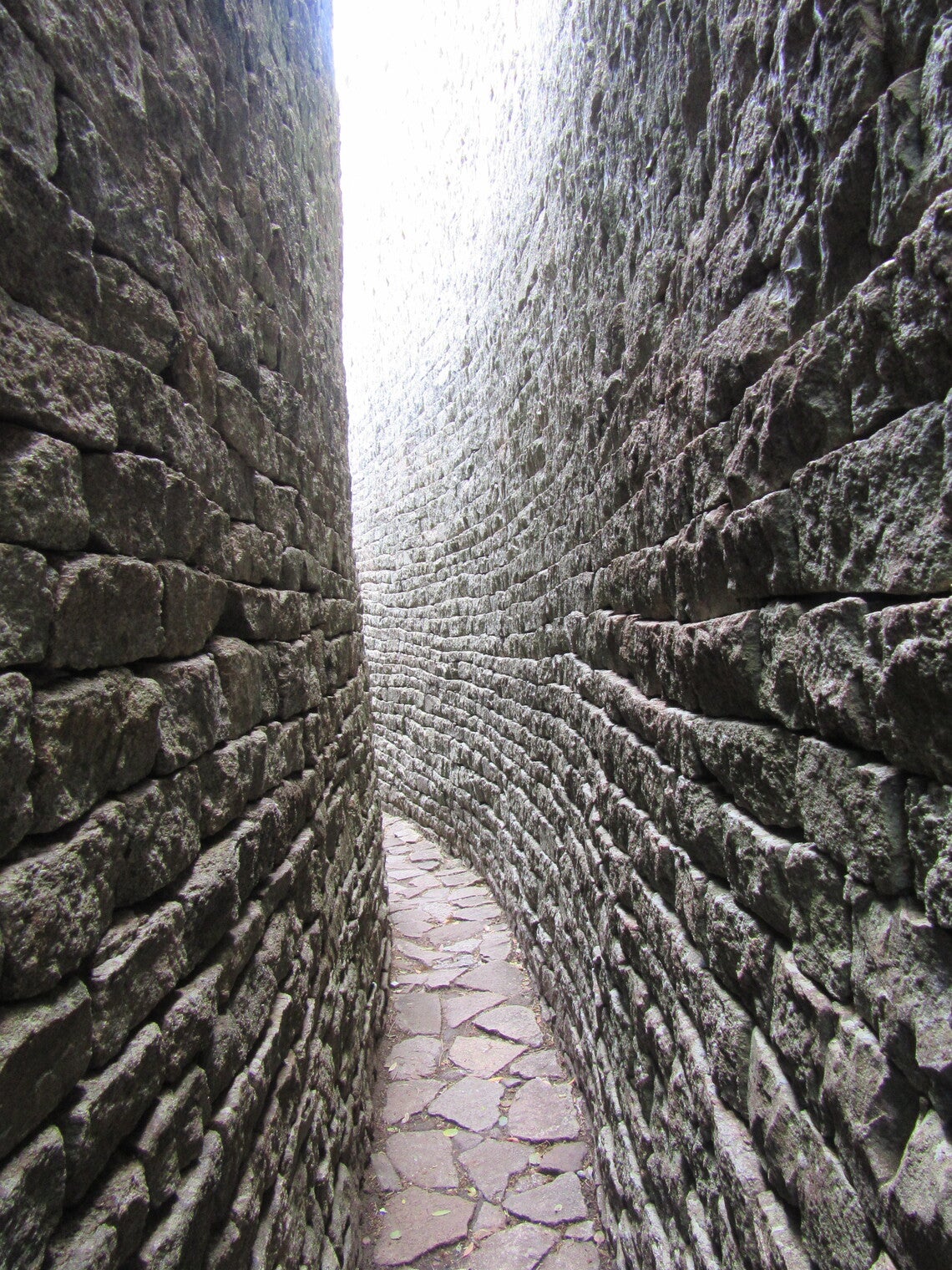 Two curved stone walls, with daylight between