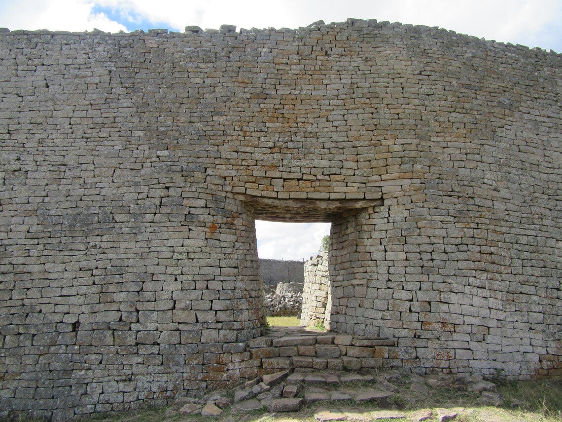 A stone wall with steps and an entry threshold