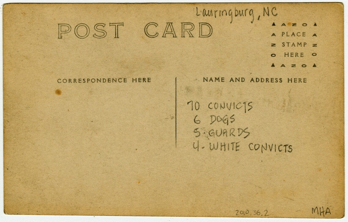 The back of the photograph is a postcard with an area labeled "Correspondence" on the left and an area labeled "Name and Address Here" and "Place Stamp Here" on the right. A handwritten inscription on the back reads: "Lauringburg, NC" at the top, with "70 CONVICTS, 6 DOGS, 5 GUARDS, 4 - WHITE CONVICTS" written in the space for name and address.