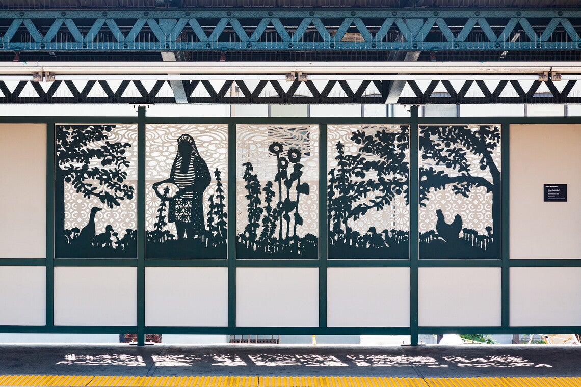 A five-piece mural made out of steel grates of a person working in a field.