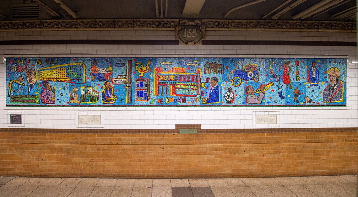 A blue tile mosaic mural with depictions of various historical figures