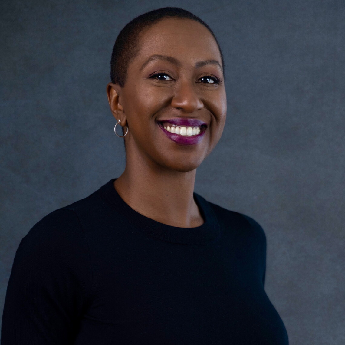 A Black woman with short dark hair wearing a black shirt.