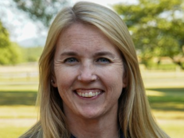 a white woman with blond hair smiling.