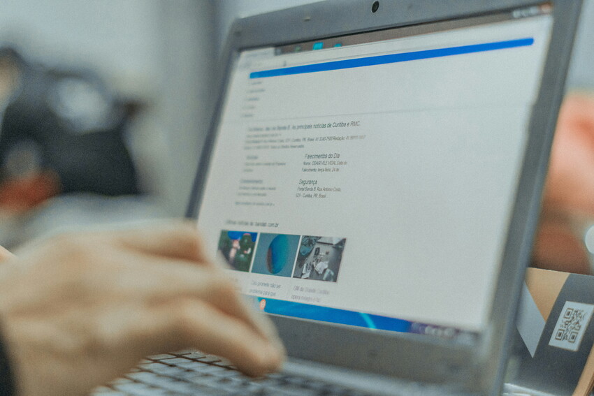 open laptop screen with hand typing